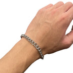 Chrome bracelet on wrist with silver-toned curb link chain