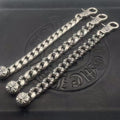 Silver-toned chain bracelet with twisted links and small flower charms, curved tips