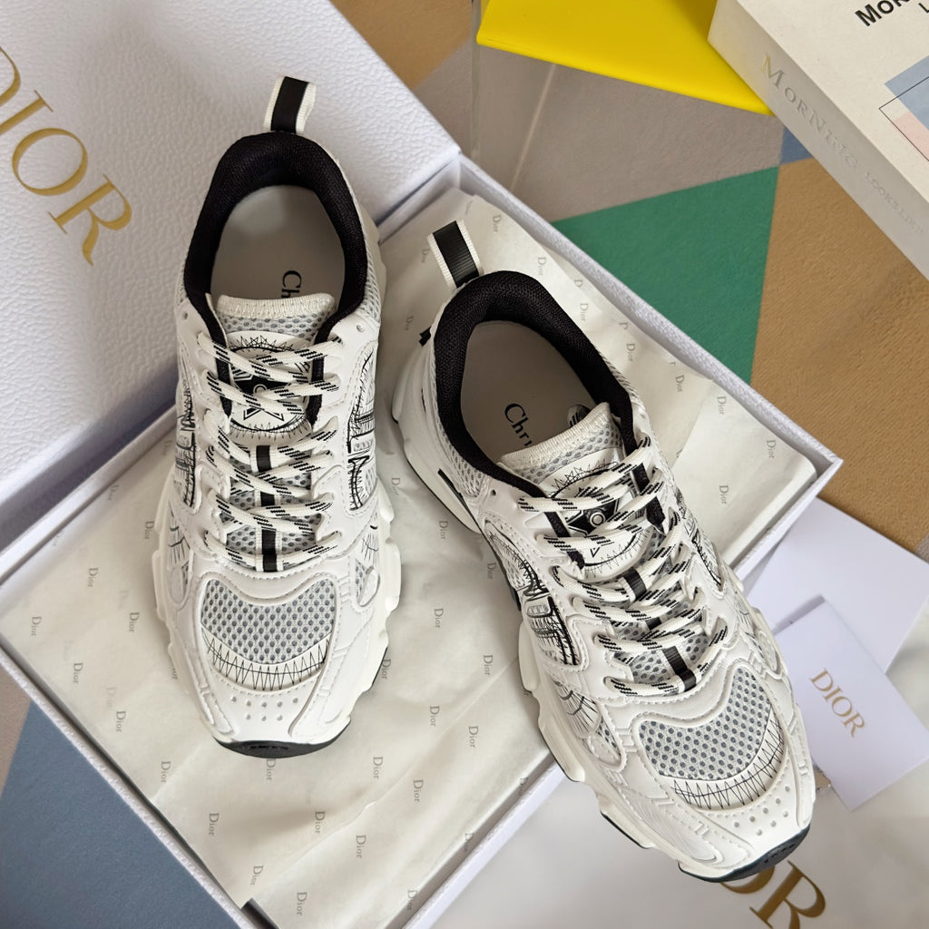 Unisex white lace-up sneakers with black graphic uppers and chunky sole