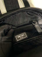 Prada Milan logo patch on black inner zip pocket, satin lining and zipper