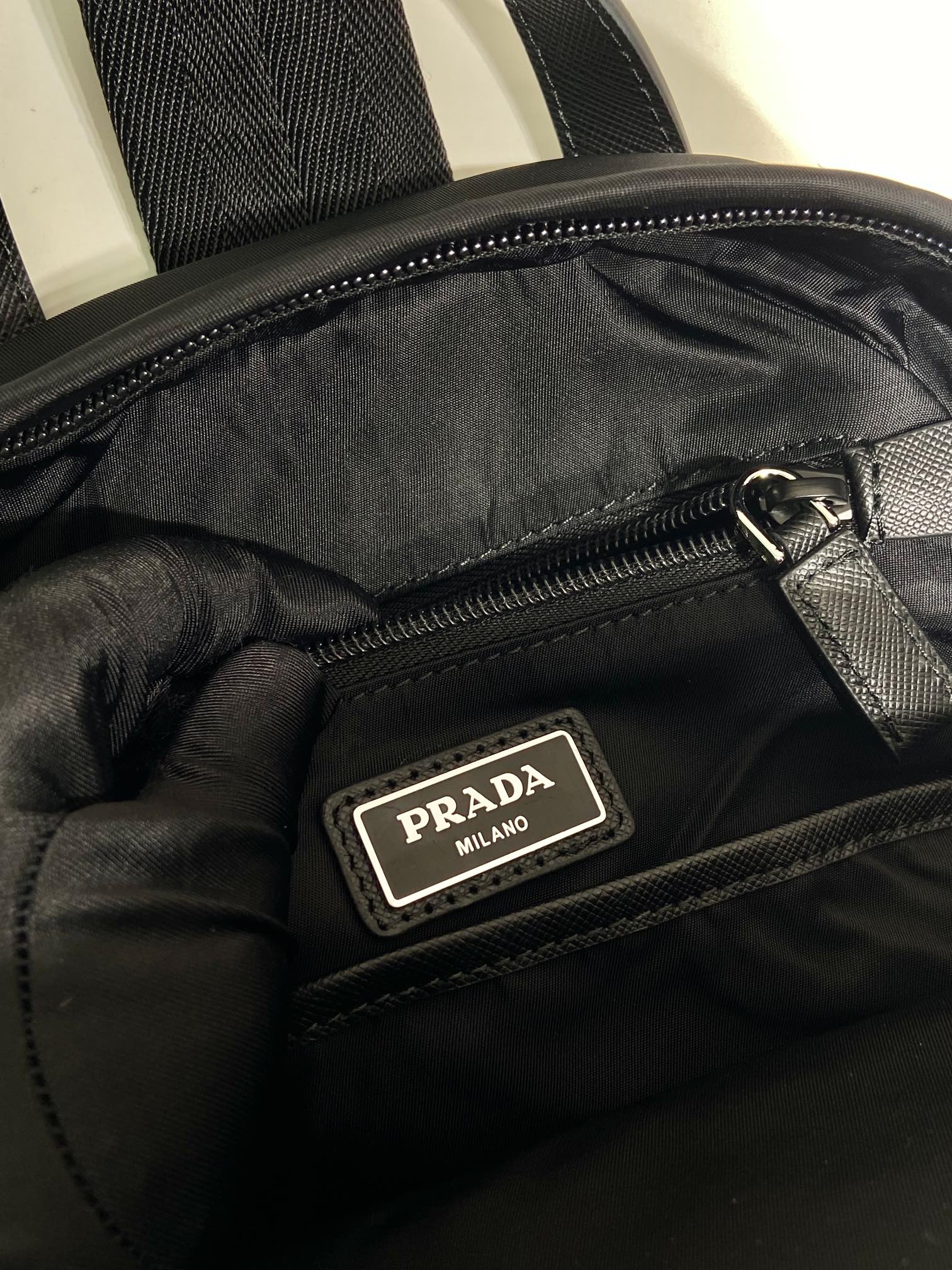 Prada Milan logo patch on black inner zip pocket, satin lining and zipper