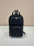 Black Prada mini backpack with zip front and top handle, logo patch on pocket