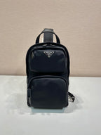 Black Prada mini backpack with zip front and top handle, logo patch on pocket