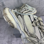 Balenciaga unisex sneaker side view with lace-up straps and layered, cushioned sole