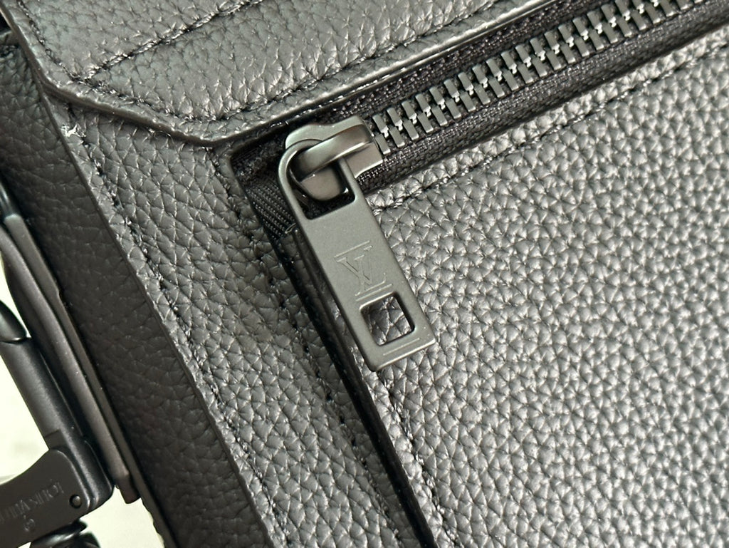 Black leather bag zipper pull and metal track hardware detail
