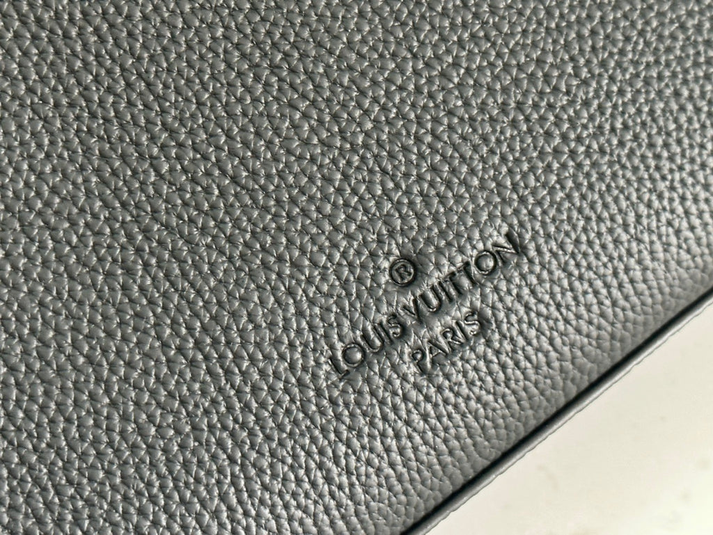 Black textured leather bag with embossed brand logo on side panel