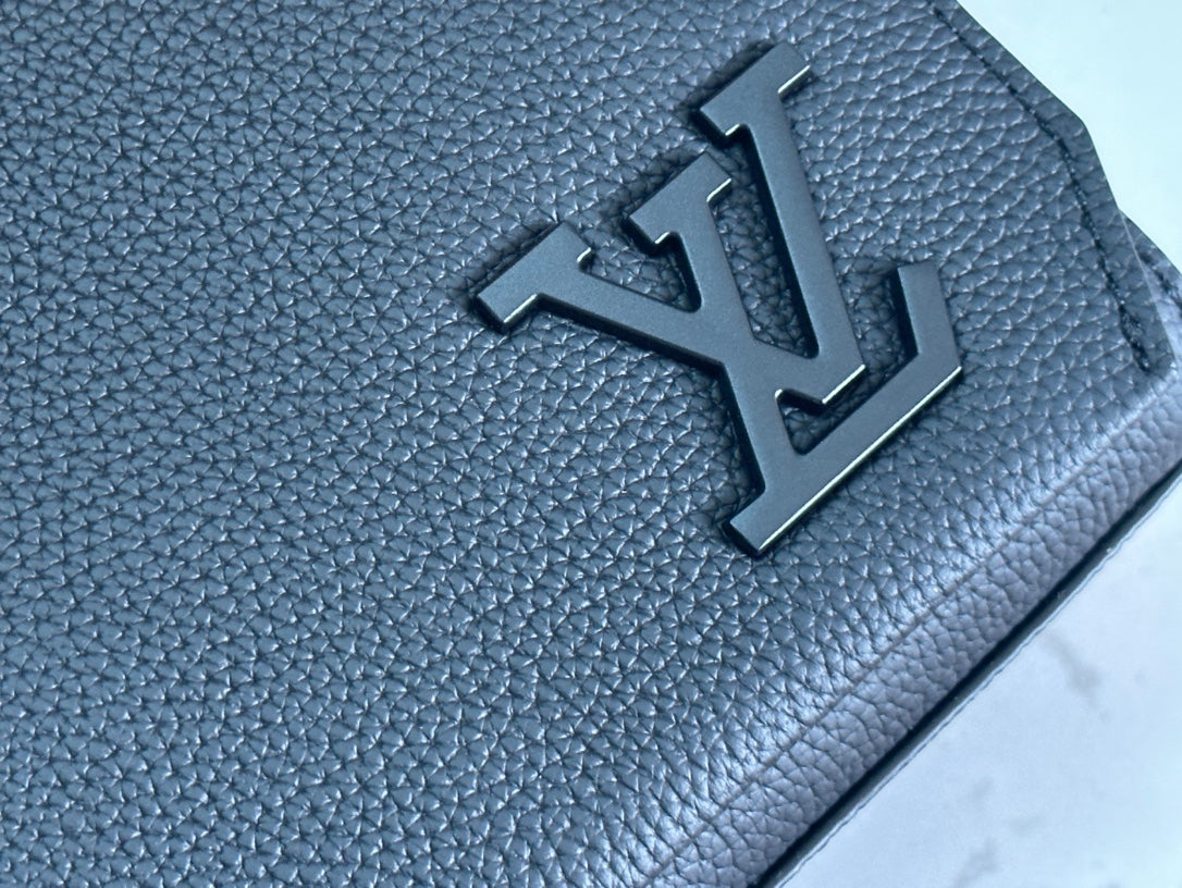 Black textured leather bag with raised LV-style emblem detail