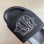 Black textured slide sandal strap with large white Dior monogram detail