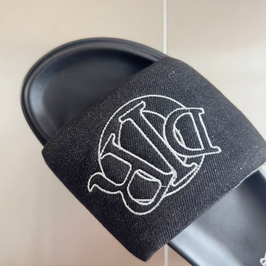 Black textured slide sandal strap with large white Dior monogram detail