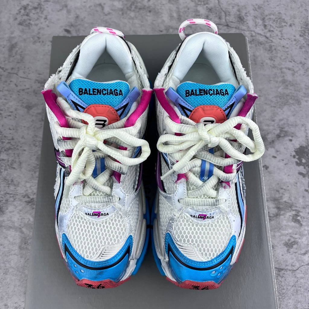 Balenciaga runner sneakers, front view of white uppers with blue, purple and magenta details