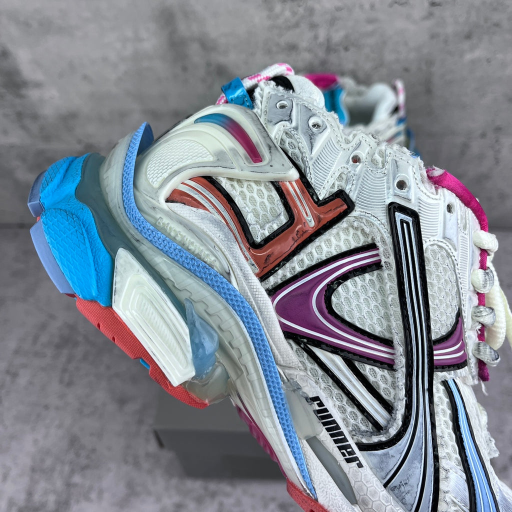 Balenciaga unisex runner sneakers, angled side view with white upper and colorful panels