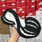 Black and white rubber outsole of unisex sneakers with tread pattern