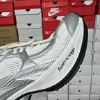 White unisex sneaker with side logo print and textured mesh upper
