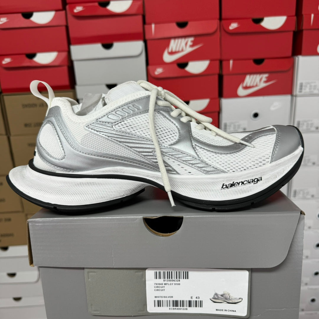 White unisex sneakers with mesh panels and black rubber sole