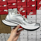 White unisex sneakers with mesh panels and sculpted midsole