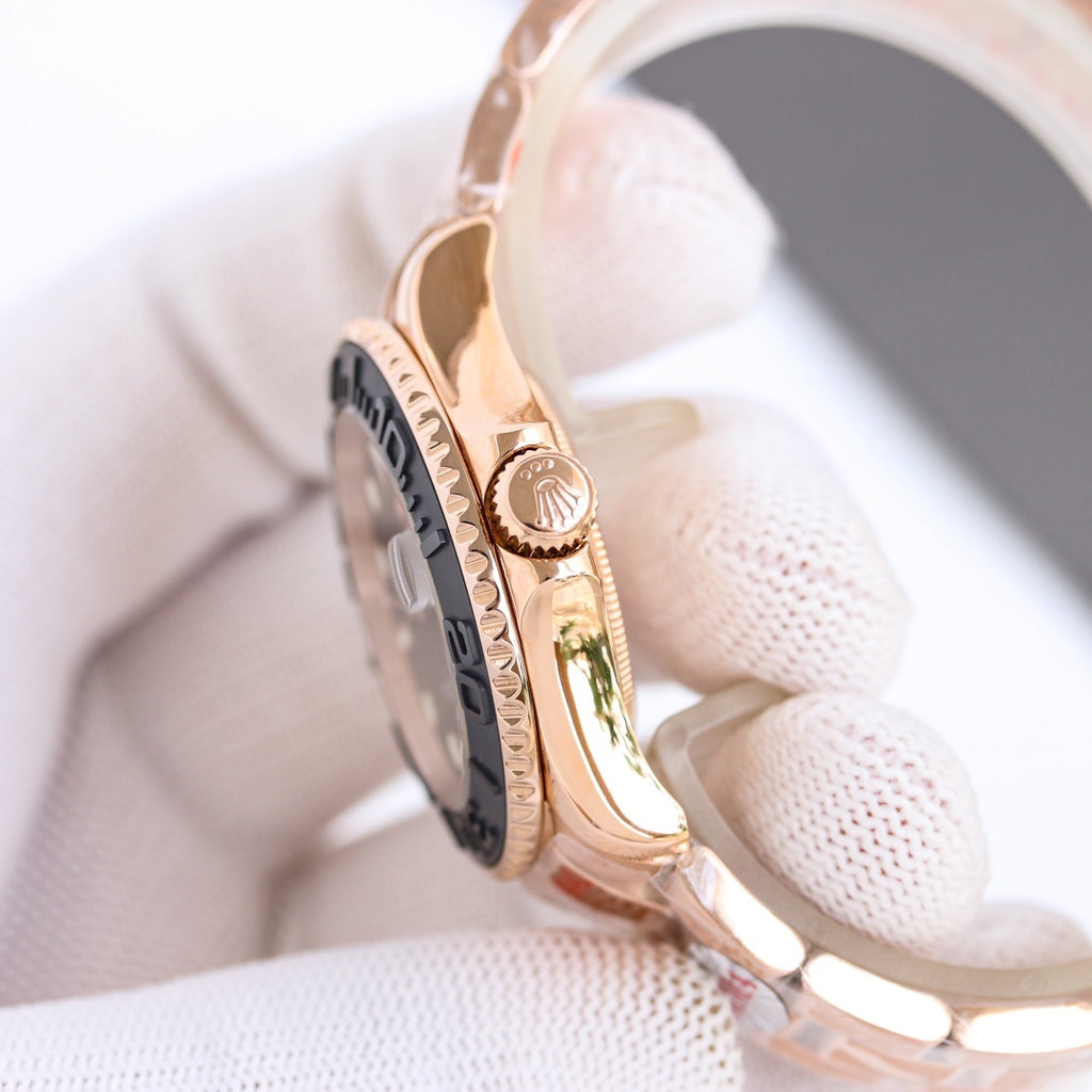 Rolex watch side view with rose-gold tone case, detailed bezel and crown on 4 o'clock.