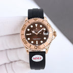 Rose-gold diver watch with brown dial, gold bezel, and black rubber strap with MMA patch
