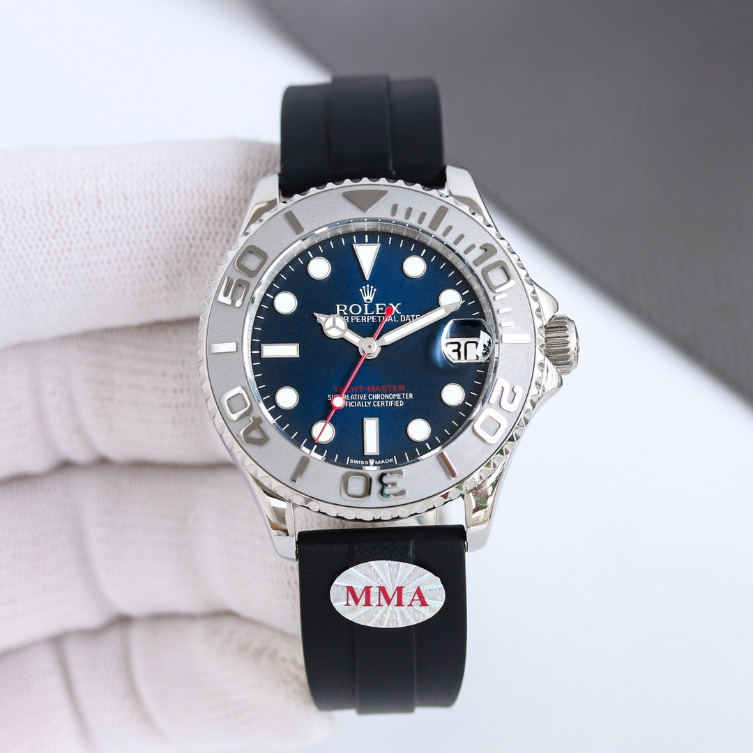 Steel diver watch with blue dial, silver bezel, and black rubber strap with MMA patch