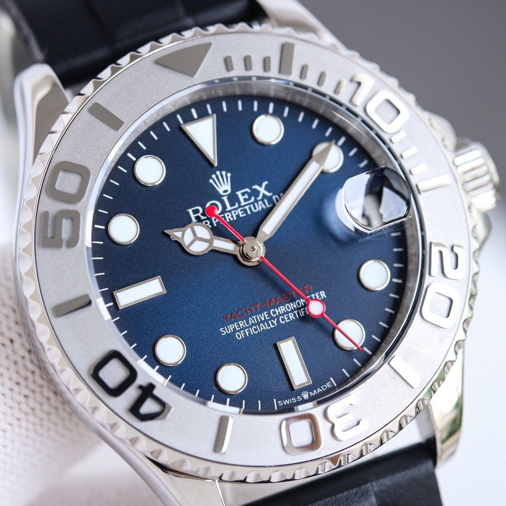 Blue dial diver watch with silver bezel, black rubber strap, and crown at right