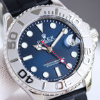Blue dial diver watch with silver bezel, black rubber strap, and crown at right
