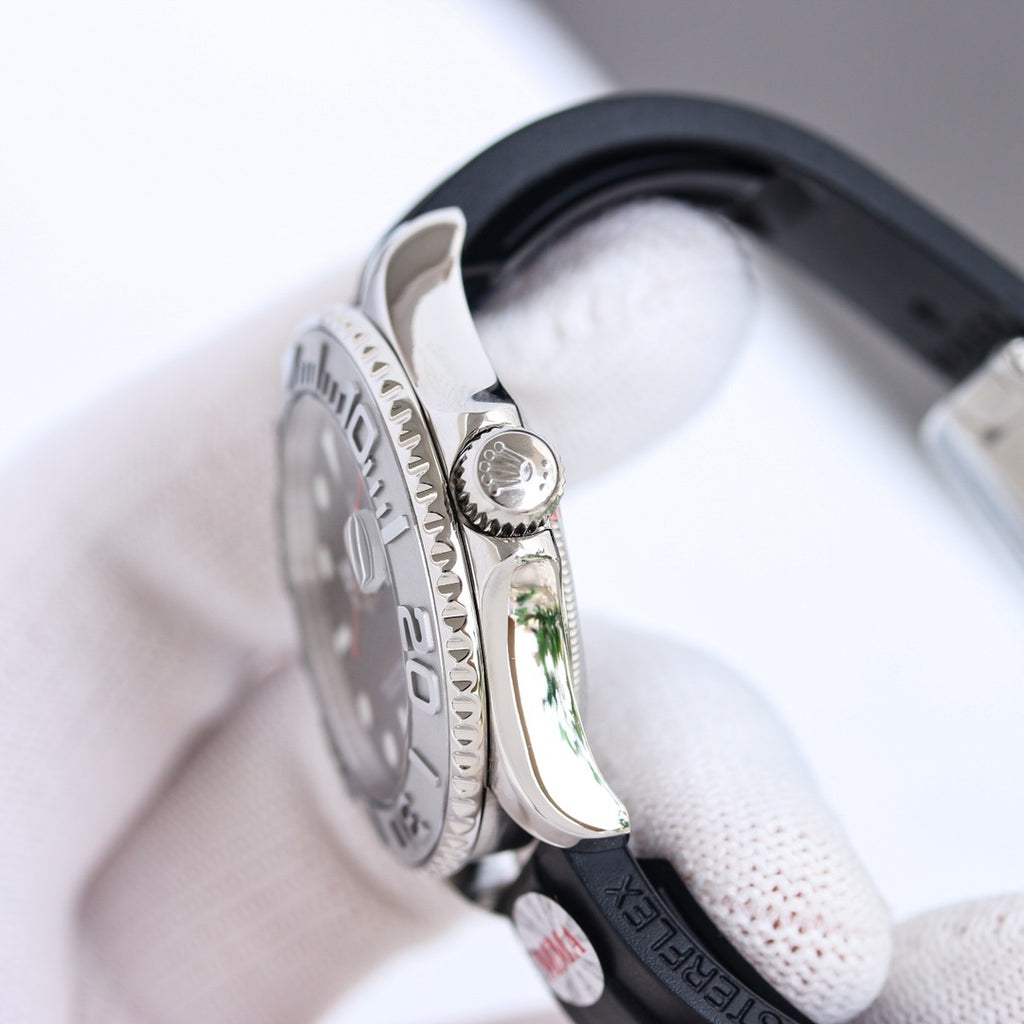Side view of stainless-steel diver watch with black rubber strap and ridged bezel