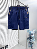 Blue Burberry swim shorts with elastic waist and drawstring, side logo