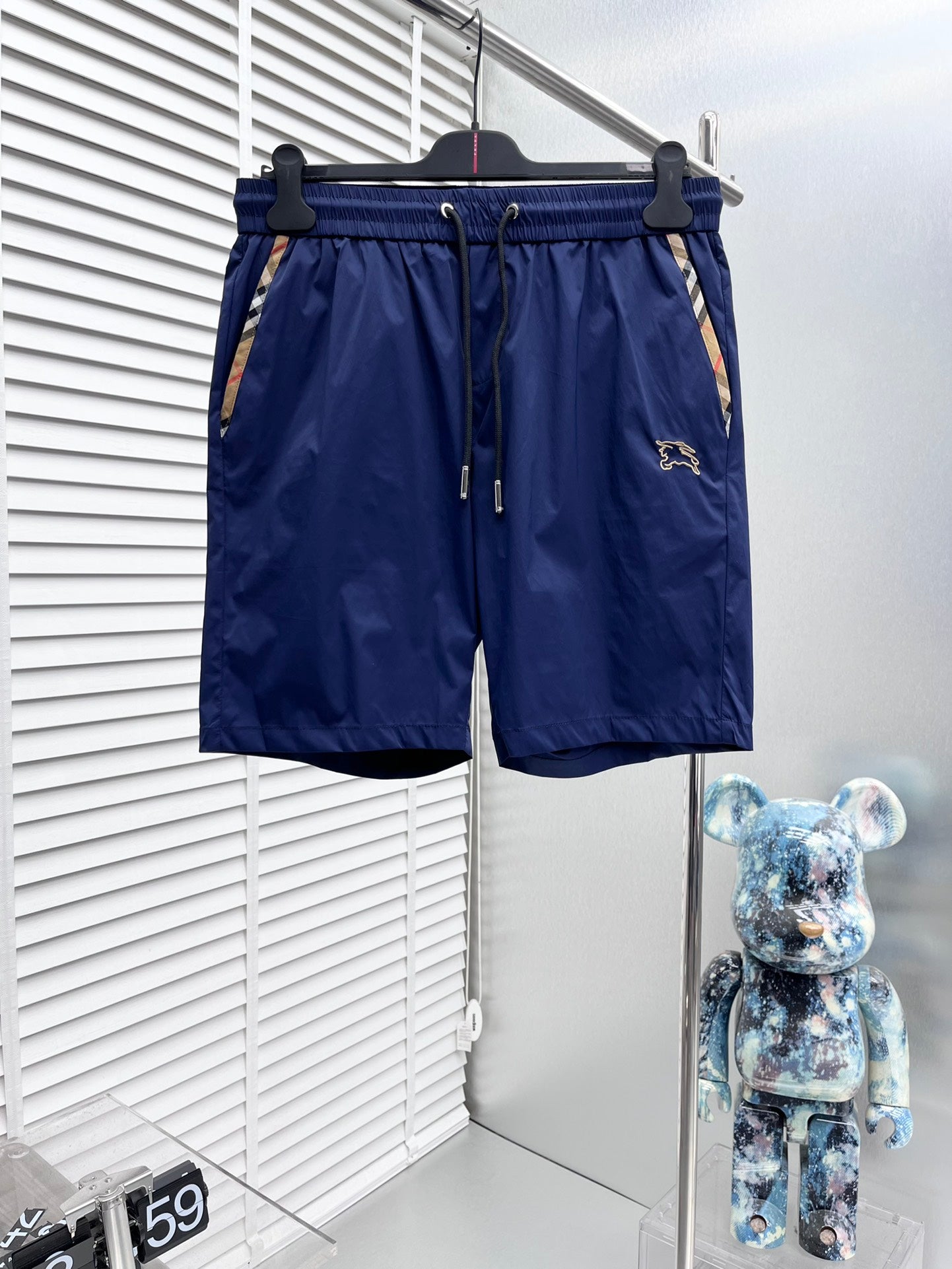 Blue Burberry swim shorts with elastic waist and drawstring, side logo