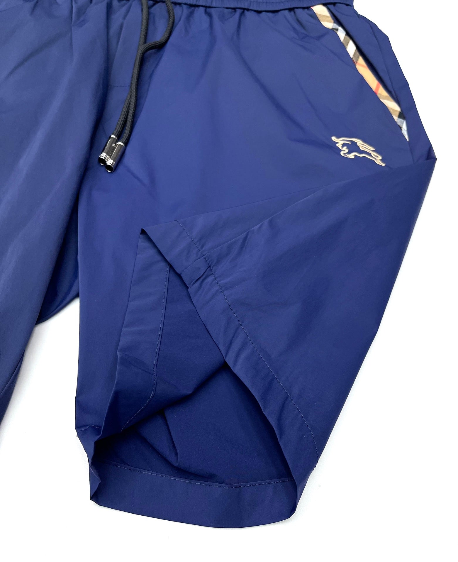 Blue Burberry shorts with zip pocket, drawstring cord, and horse logo