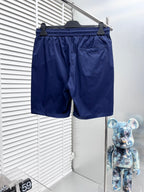 Blue Burberry swim shorts with elastic waist, drawstring, and side logo detail