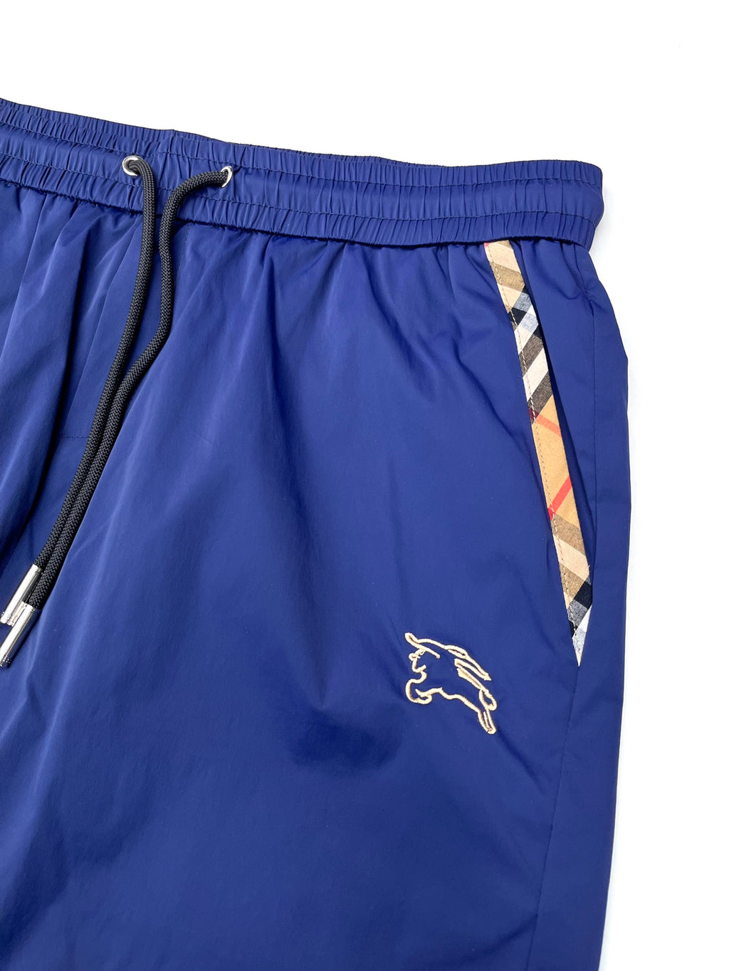 Blue Burberry shorts with elastic waistband, drawcord tie, and side stripe detail