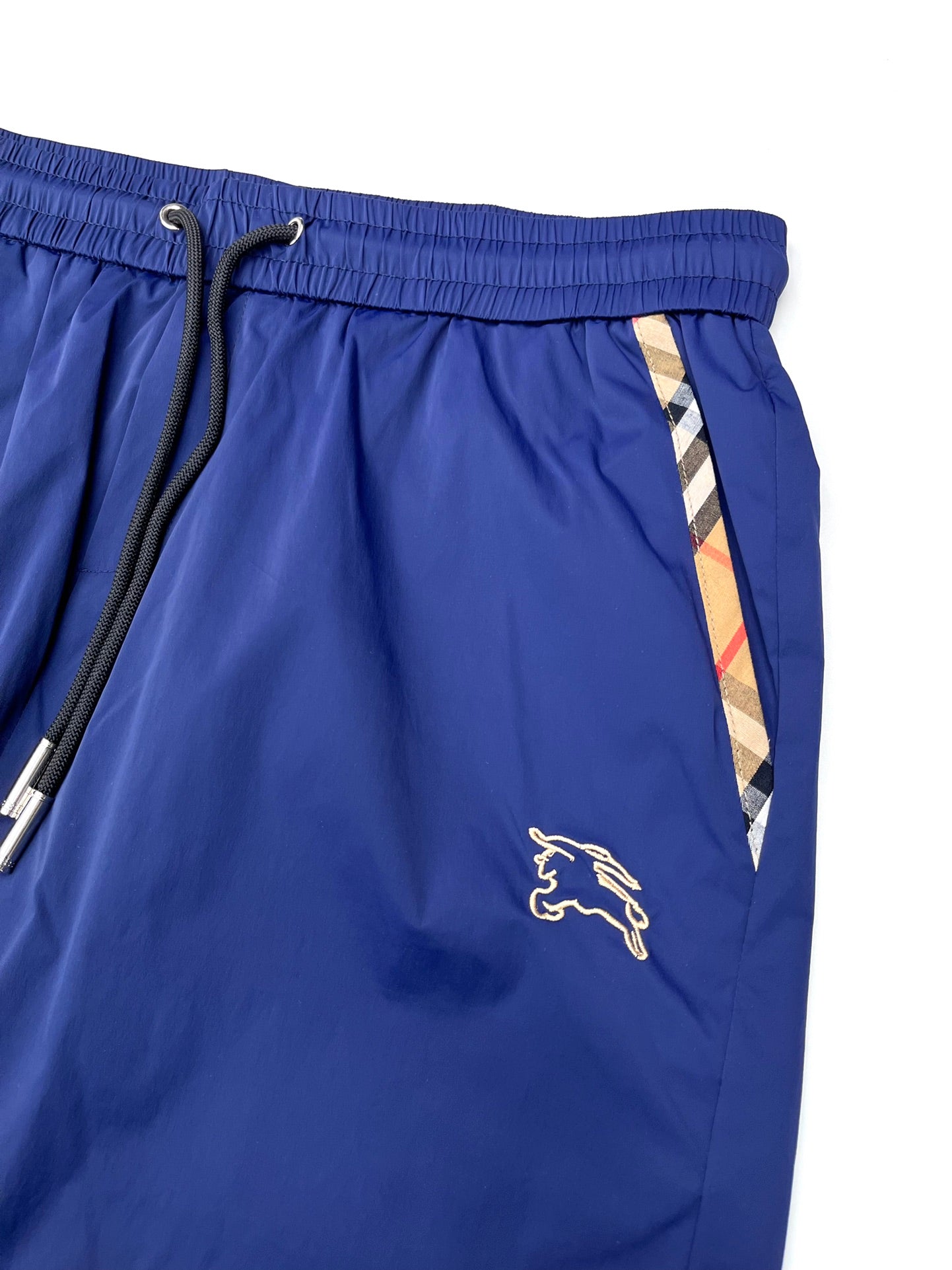 Blue Burberry shorts with elastic waistband, drawcord tie, and side stripe detail