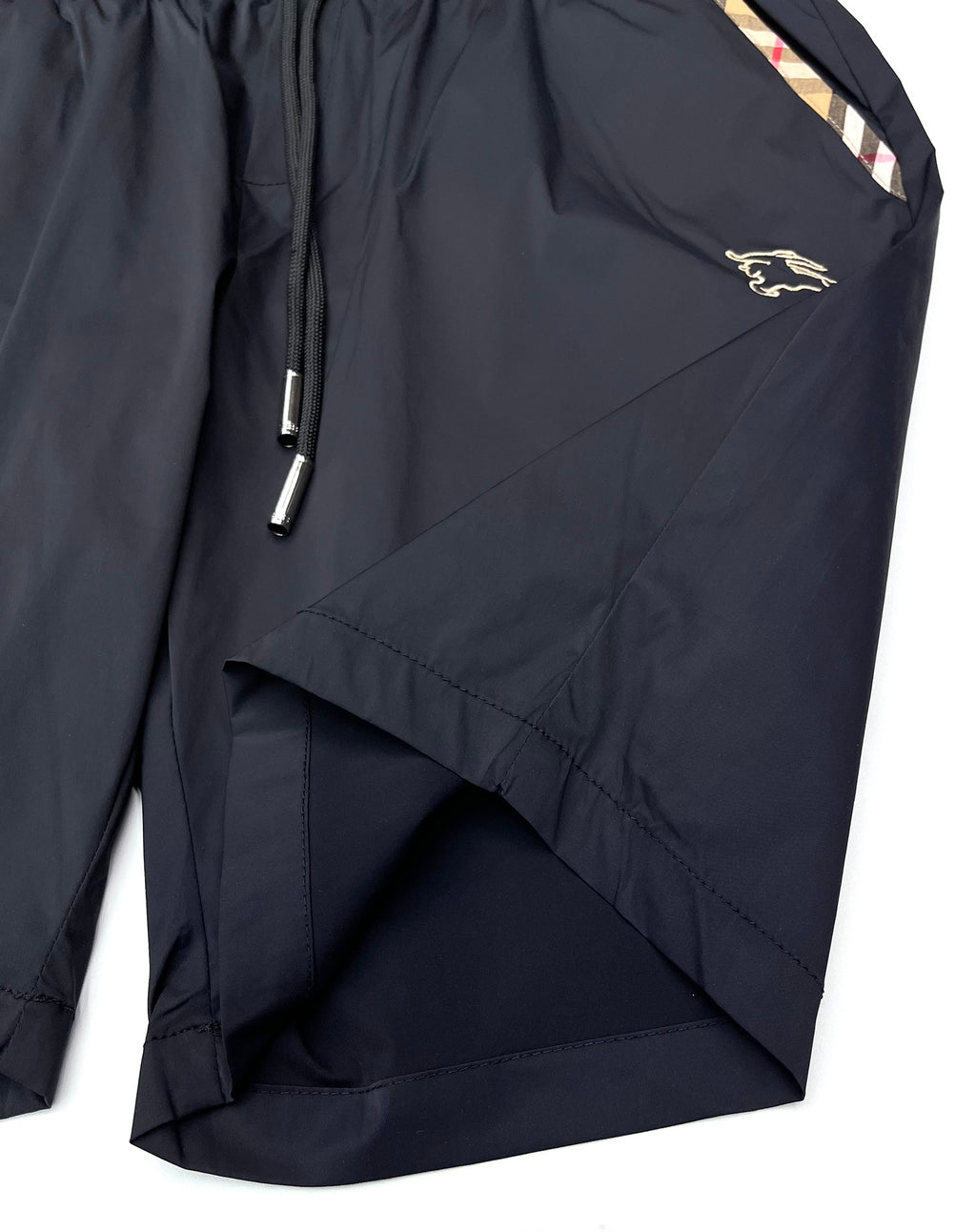 Dark navy Burberry shorts with side pocket and diagonal seam, gold logo