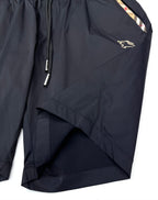 Dark navy Burberry shorts with side pocket and diagonal seam, gold logo