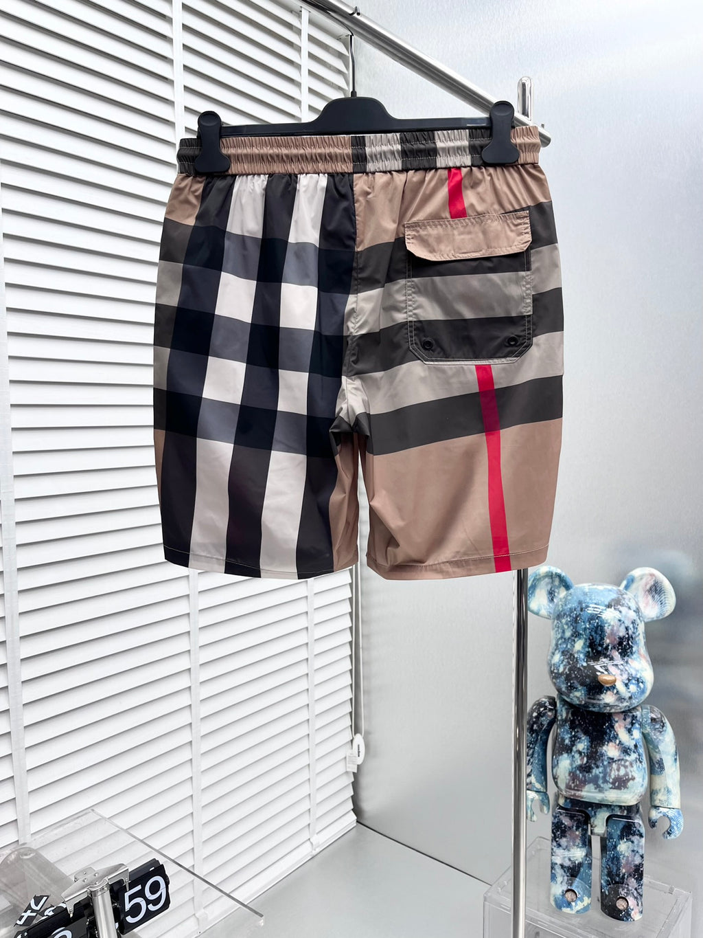 Burberry plaid shorts, side view: beige and navy check blocks with red stripe, elastic waist