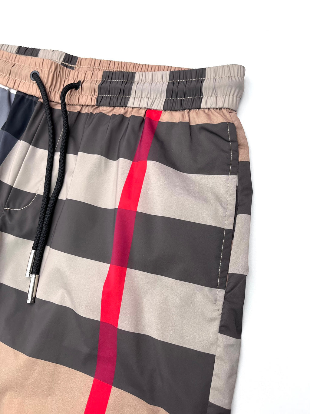 Burberry plaid shorts waistband close-up with elastic back and drawstring, beige/navy checks