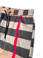 Burberry plaid shorts waistband close-up with elastic back and drawstring, beige/navy checks