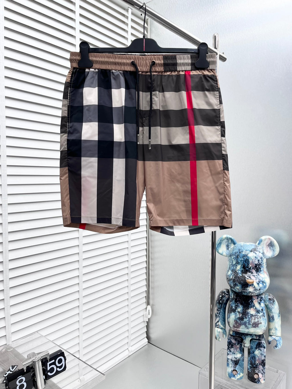Burberry plaid shorts with elastic waistband and black drawstring, beige and navy checks with red stripe