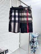 Burberry check shorts with elastic waistband, drawstring, black white gray panels, red stripe