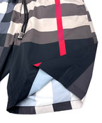 Burberry check shorts leg detail with curved hem and red plaid stripe