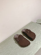 Balenciaga sandals laid flat in dark brown sparkly fabric with buckle strap