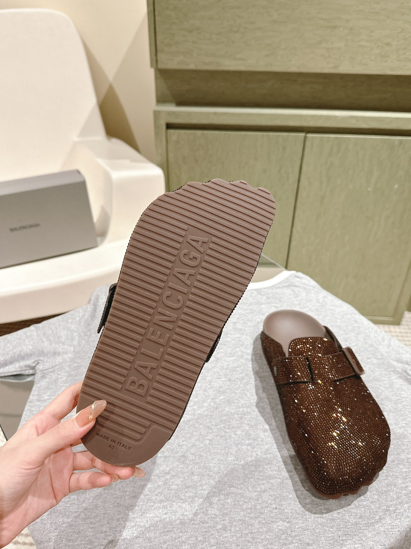Balenciaga sandal outsole with raised texture and dark brown rubber sole