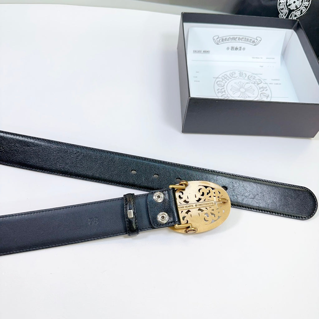 Black leather belt with gold buckle mechanism and visible adjustment holes.