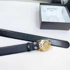 Black leather belt with gold buckle mechanism and visible adjustment holes.