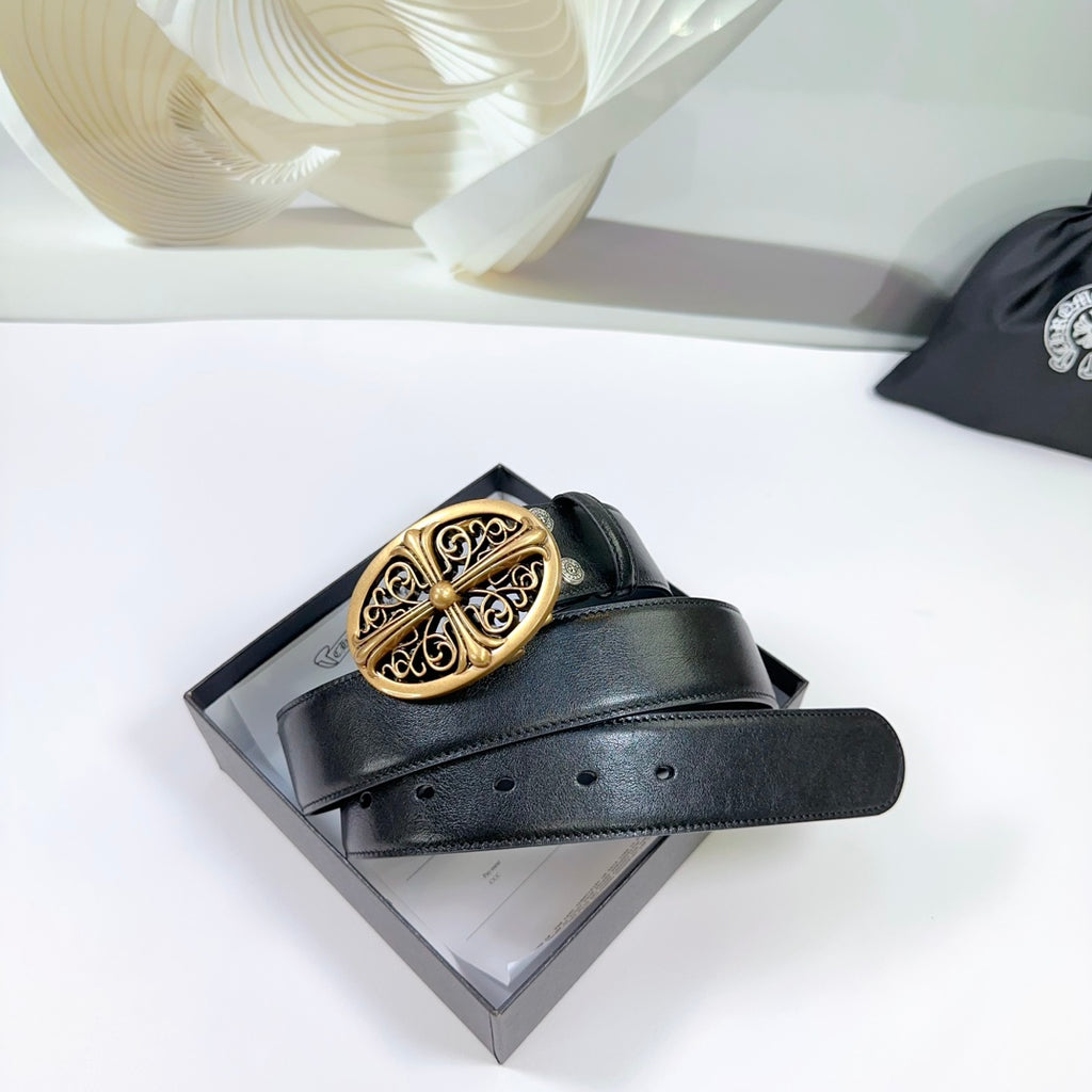 Black leather belt with gold oval buckle resting on packaging.