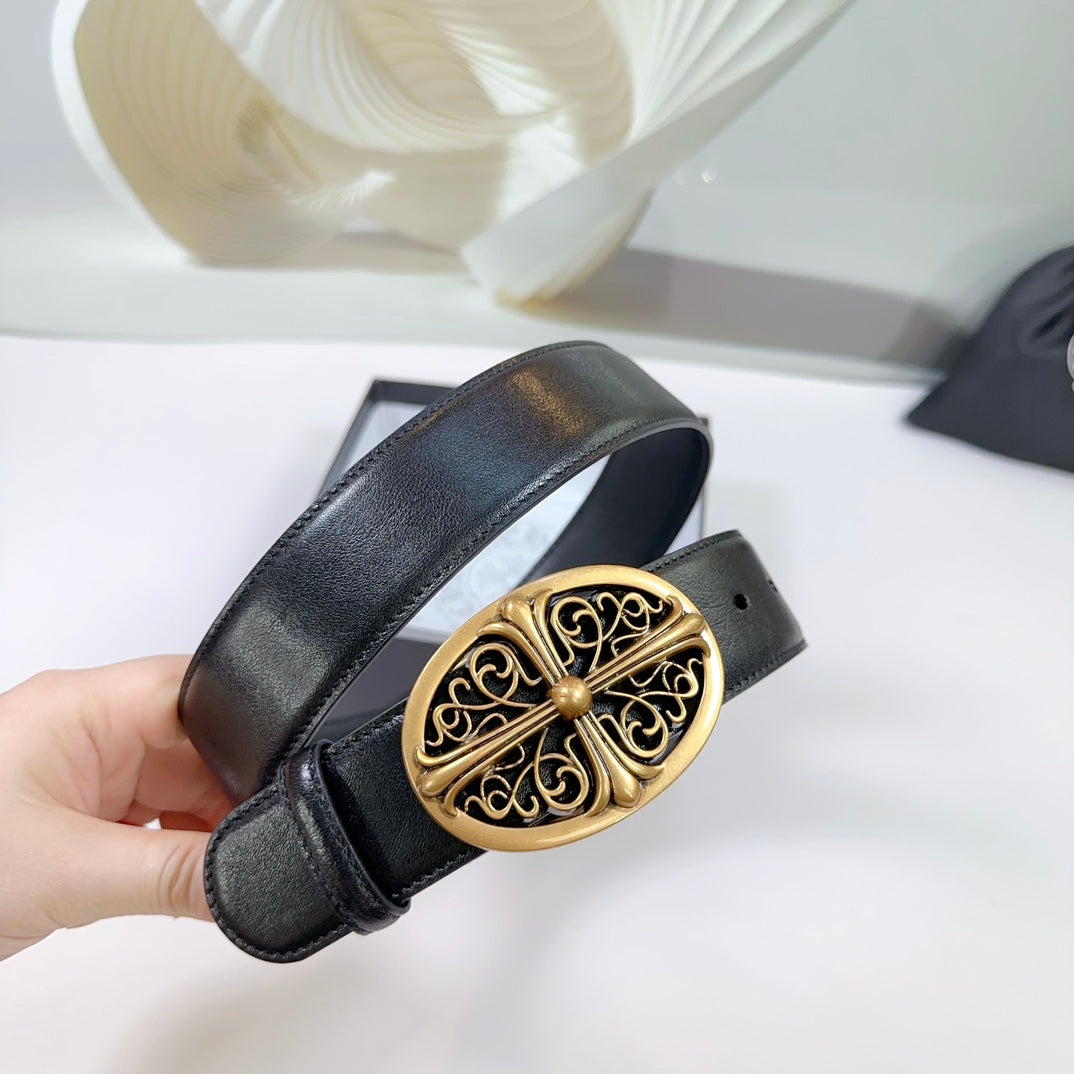 Black leather belt held up with gold oval buckle and textured strap details.