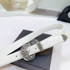 White leather belt with silver filigree buckle and ornate patterned center plate