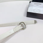 White leather belt with oval silver buckle and adjustable strap with small engraved marks