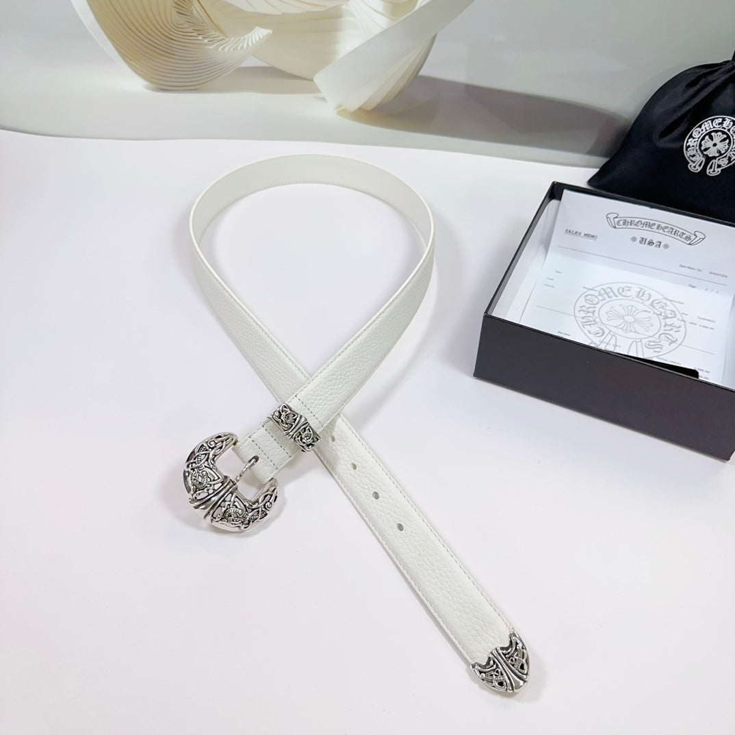 White leather belt with silver filigree buckle and adjustable strap with punched holes