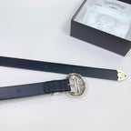 Dark leather belt with silver buckle, shown with the strap extending across the table