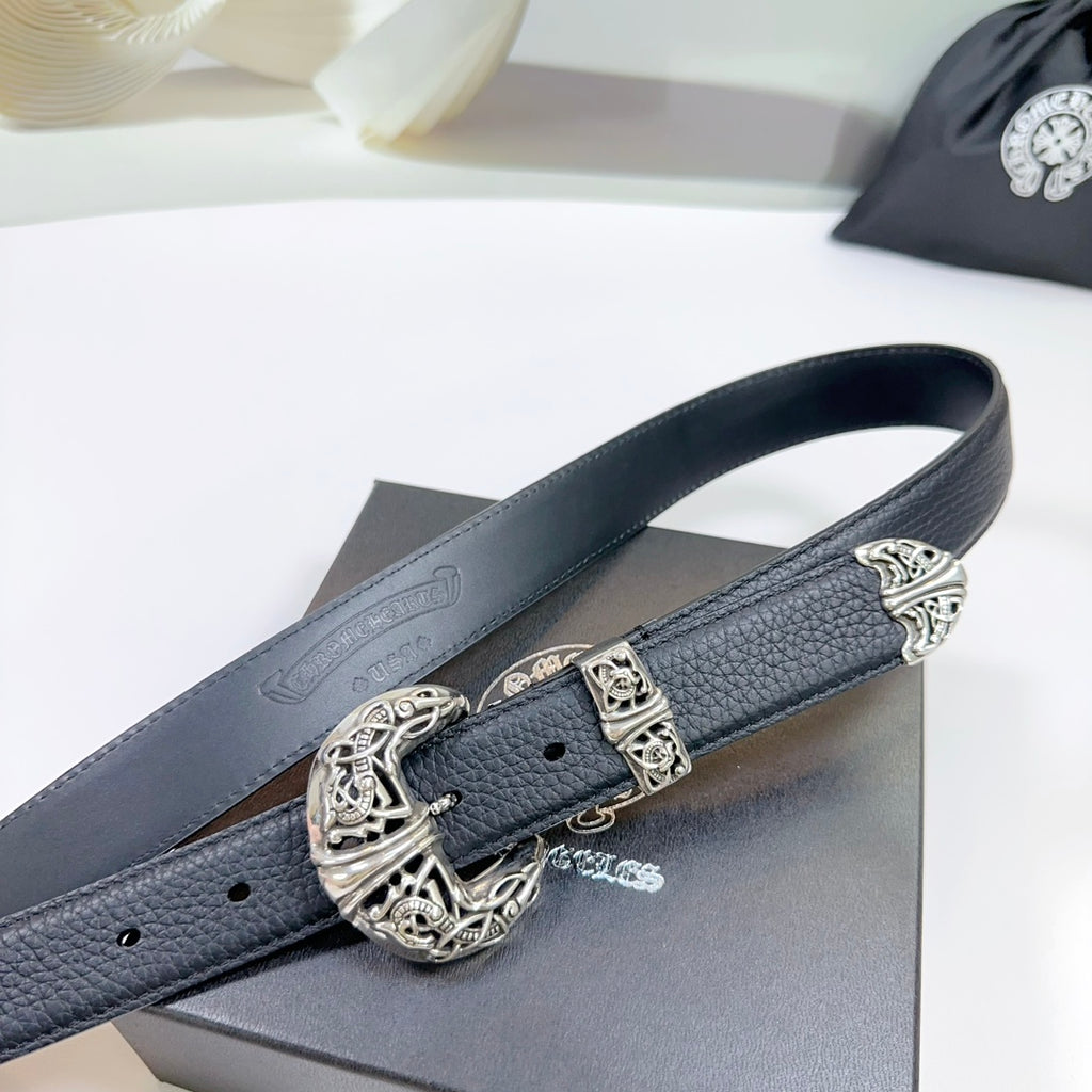 Dark leather belt with ornate silver buckle and keeper, close-up on the strap